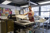 Calum Wallis placing paper on top of a stone