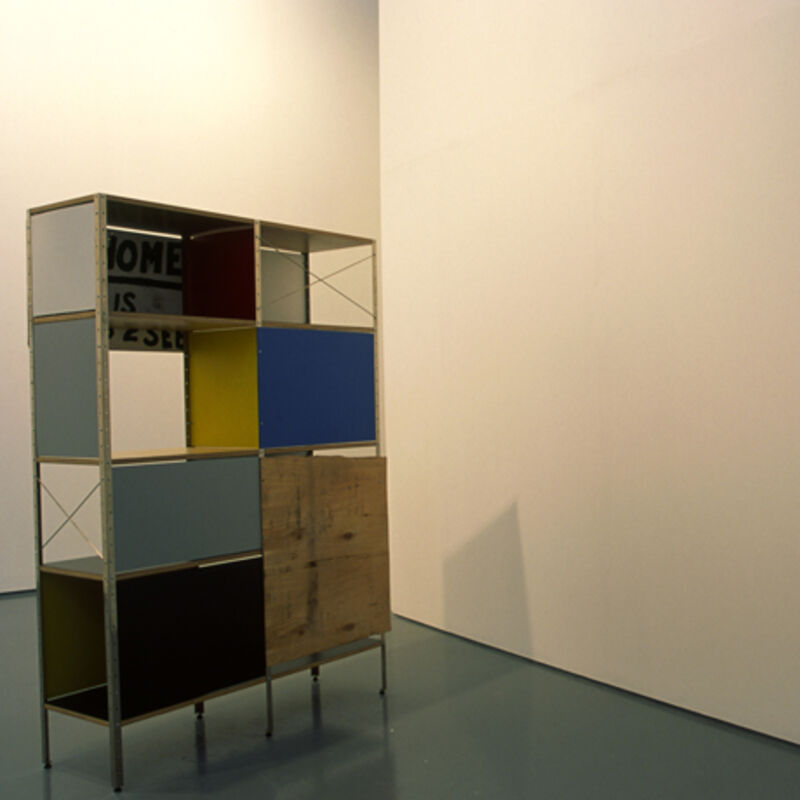 A sculpture from the Trauma exhibition. A square cabinet made out of various coloured blocks and metal.