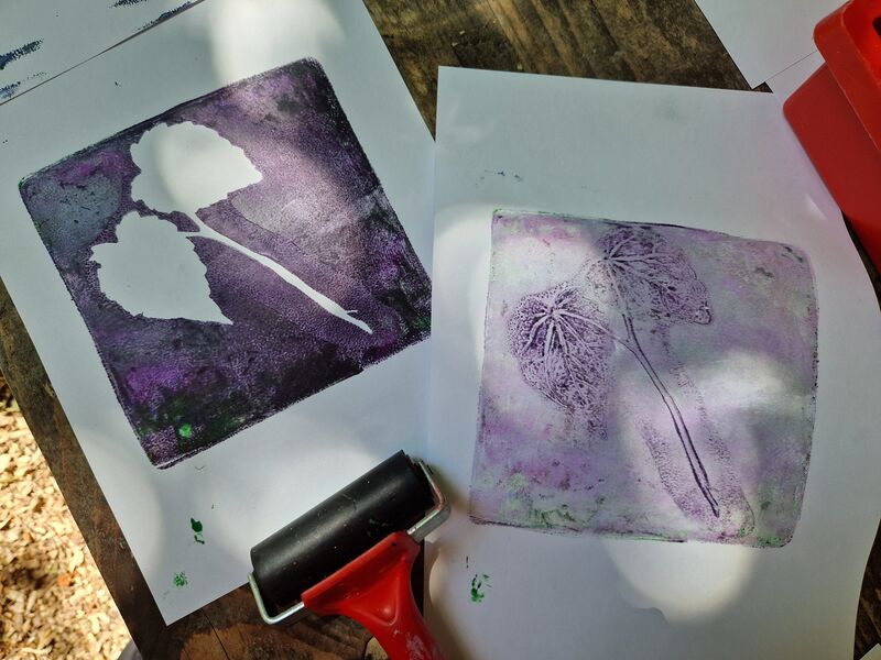 Two gelli prints made using leaves and purple inks