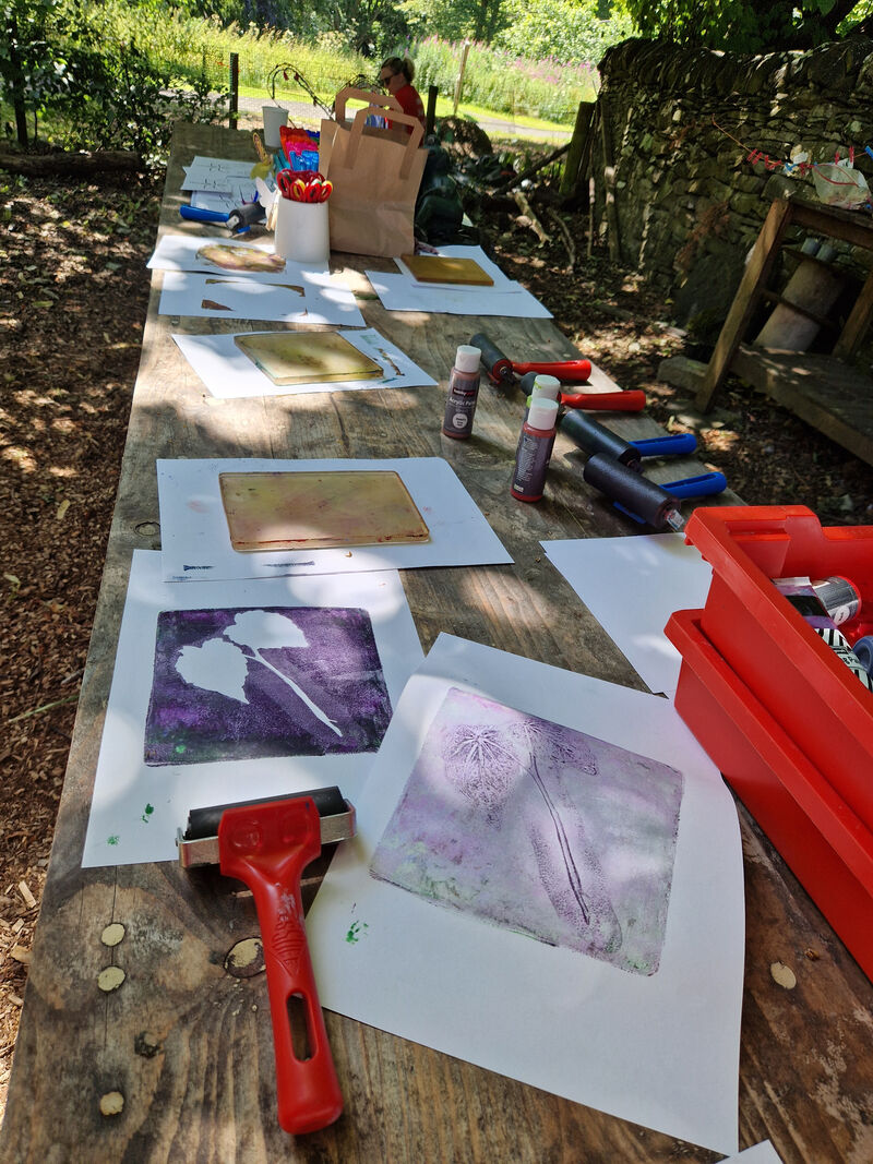 Outdoor table set up for gelli printing with DCA bunting in the background
