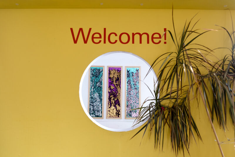 Welcome sign above a circle window into the Create Space Play Box