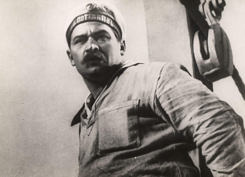 A black and white of a man in a sailor hat scowling