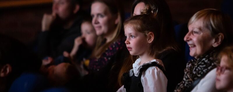 A young girl and her family enjoying a film at DCA