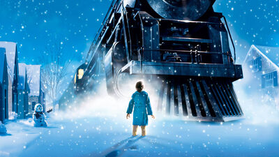 Animated still shows a small boy looking at a huge steam train in the snow