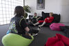 People sitting on bean bags in the Dundead Green Room