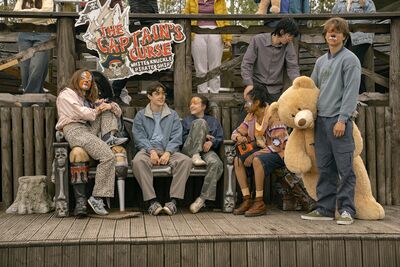 A group of teens at a funfair, their faces painted