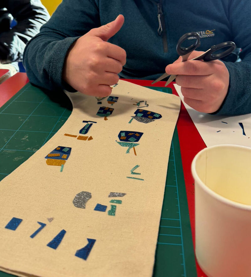 Person cutting out vinyl to decorate a stocking