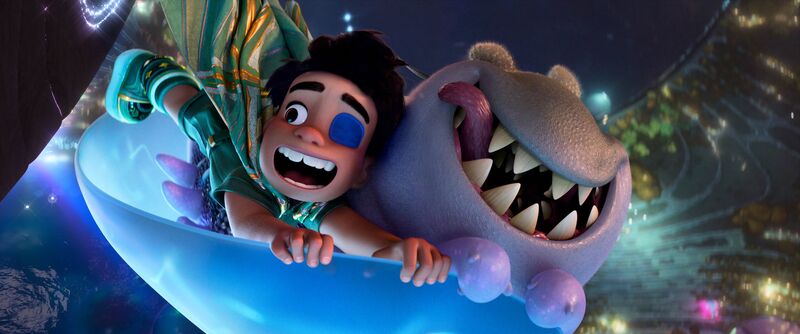 A little boy flies on a magic carpet with a worm-like monster with sharp teeth yet a friendly expression.