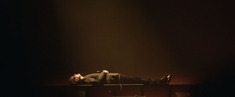 Jarvis Cocker lies on his back on stage
