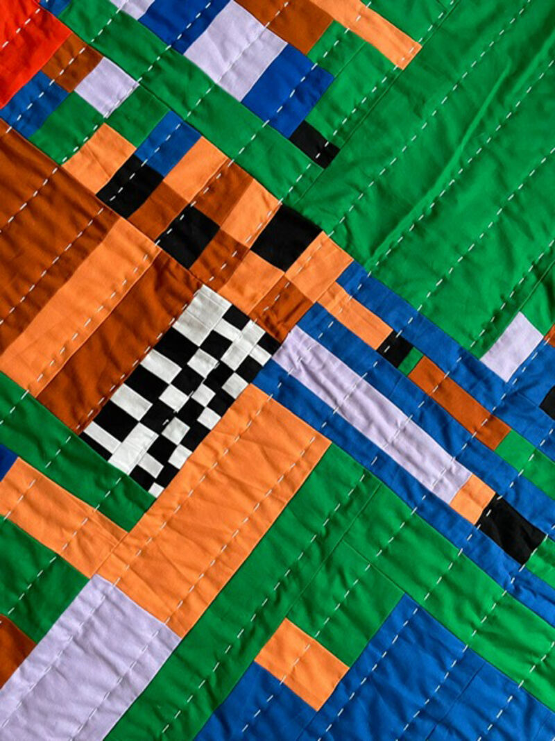 Quilted hanging made with multi coloured fabric pieces