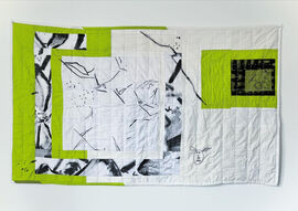 Quilted wall hanging made with green and white fabric with painted elements