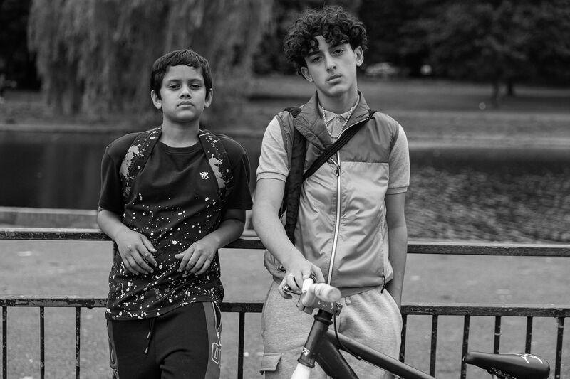 Two south asian teen boys with a bike