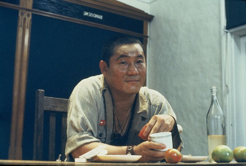 A Japanese man sits at a table