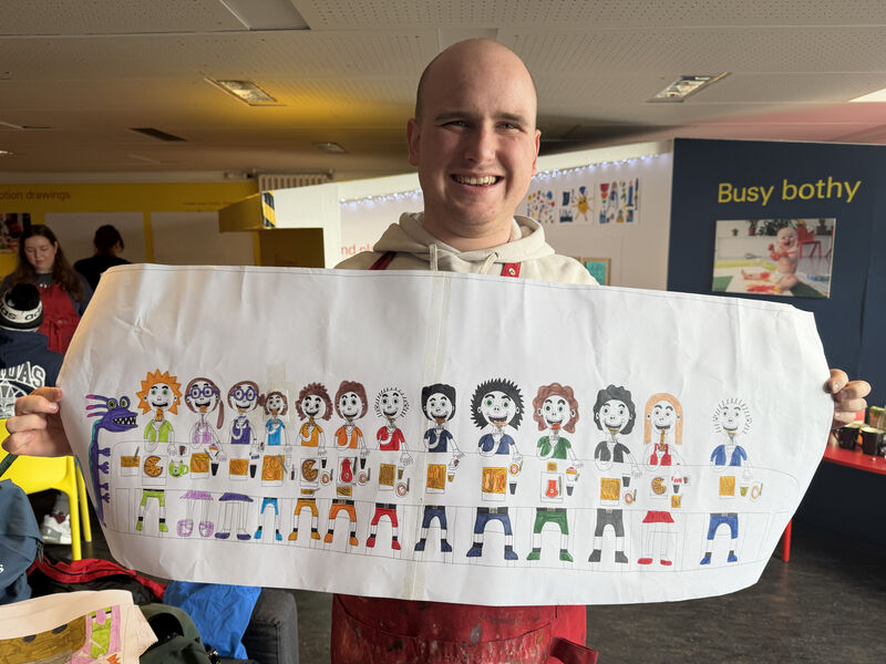 Person holding up a design for a lampshade