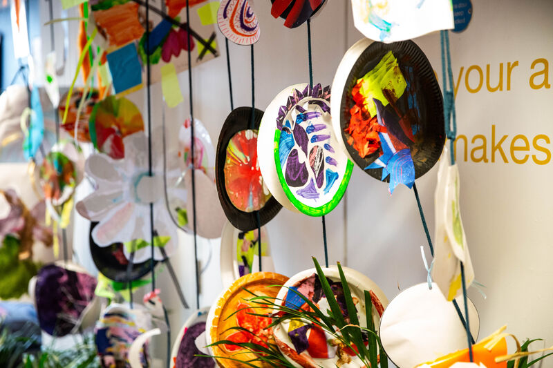 Painted paper plates hanging up in Create Space