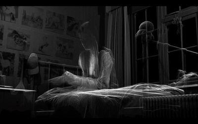 A thin outline of a young girl sitting on a bed in a black-and-white image