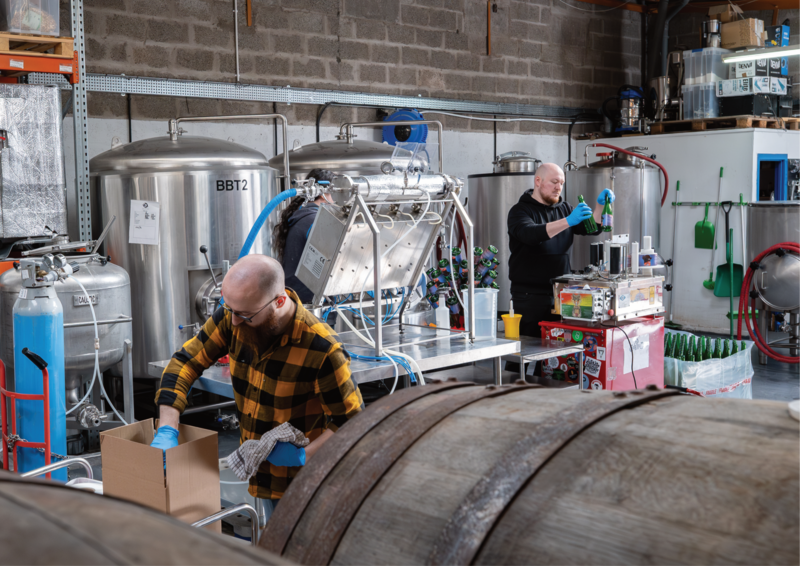 Two people working in Holy Goat brewery