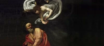 An angel speaks to a saint in an oil painting by Caravaggio