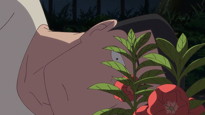 An anime still shows a man lying on his side looking at red flowers