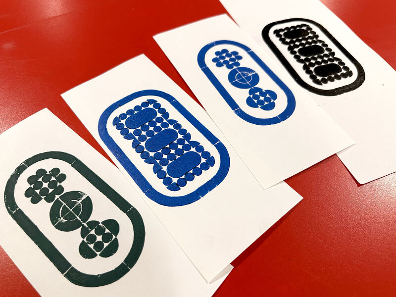 Selection of lego prints on white paper using different coloured ink