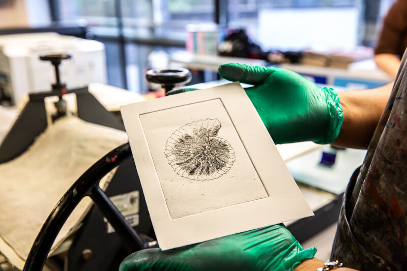 Morgan Academy pupil showing an etching print of a shell