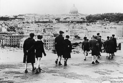 A photograph from the 1940s of a group of children walking in Rome. 