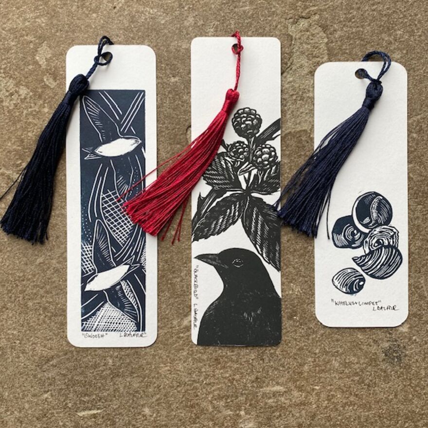 Three hand printed bookmarks featuring burd, plant and shell designs