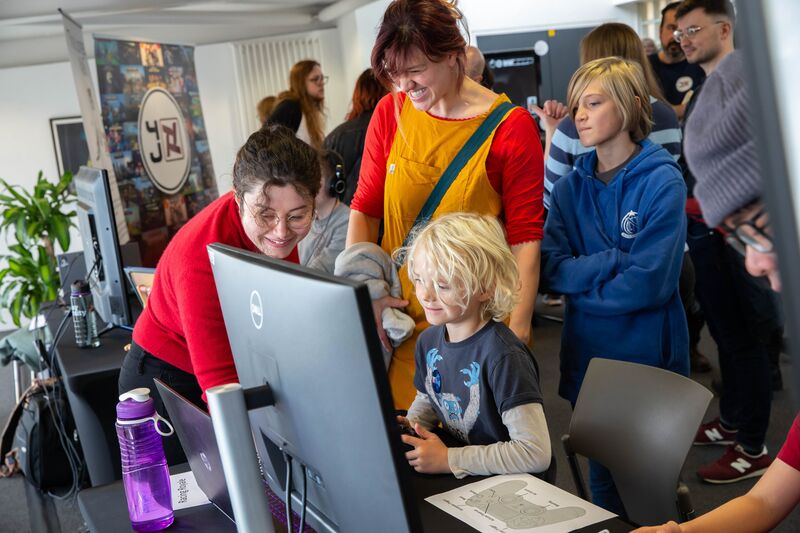 A family enjoy a game together at Drop in and Play