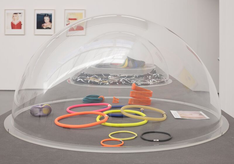 From the exhibition 'Spring / Summer 2015''. A very large glass dome covers brightly coloured circles that look like hair bobbles, in DCA Galleries.