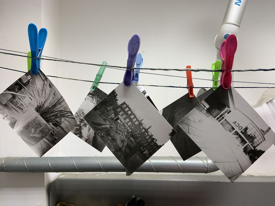 Black and white photos of DCA taken with a pinhole camera hanging up to dry