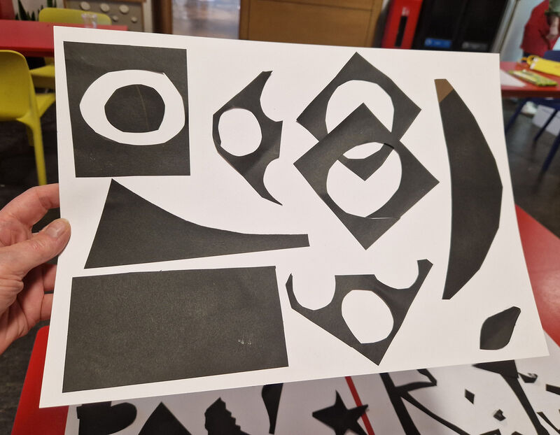 Collage of black shapes on white paper