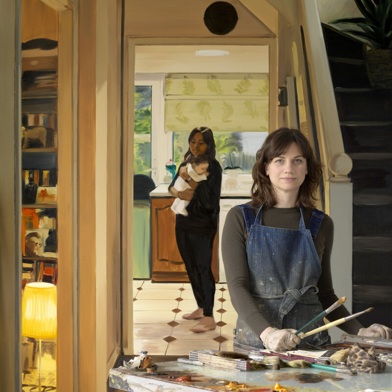 A women wearing a paint stained apron and holding brushes stares directly at the camera, behind her another women holds a baby 