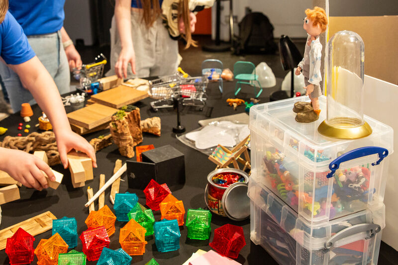 People selecting props from a table 
