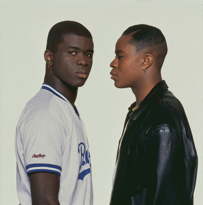 Two young Black men face each other