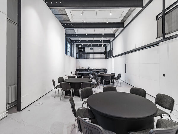 a large room with circular tables