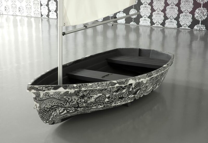 A white sailing boat from Johanna Basford's exhibition is decorated with intricate black ink patterns.