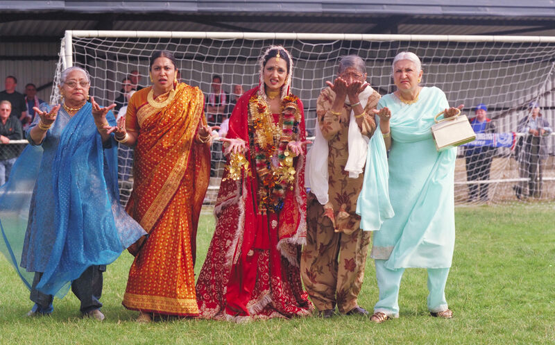 A family of asian mums and grandmas on the football pitch