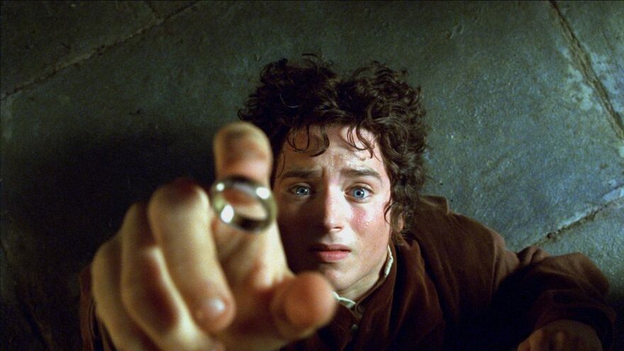 A hobbit catches the One Ring on his finger in The Lord of the Rings