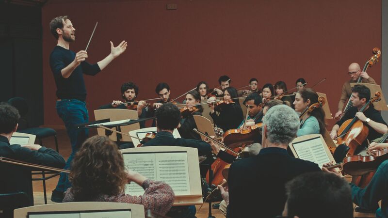 A man conducts an orchestra.