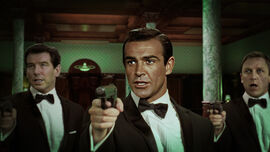 Pierce Brosnan, Sean Connery and Daniel Crag as James Bond all point their guns at the camera