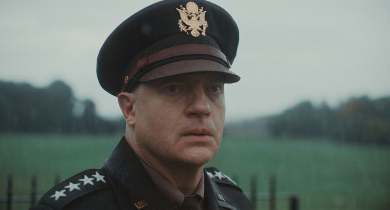 A general stares apprehensively in a rainy field