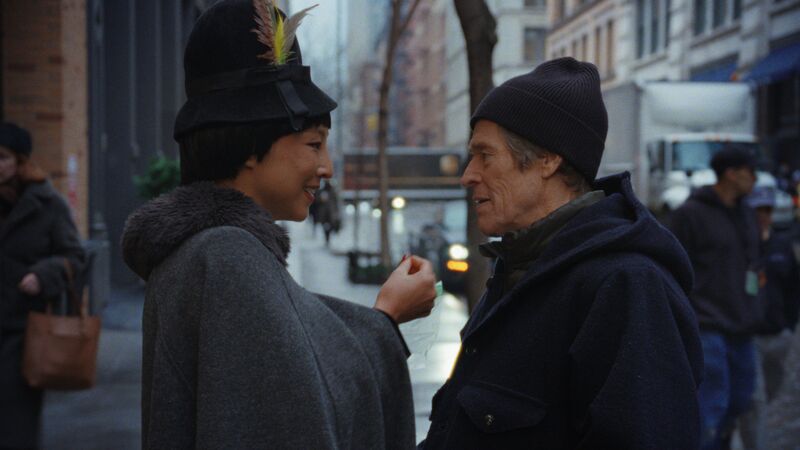A woman and man talk on a wintry street