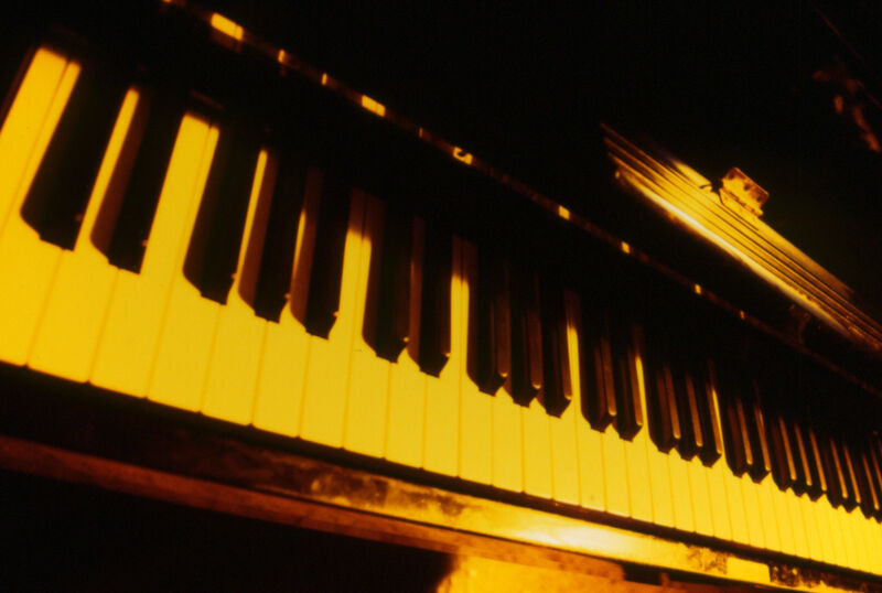 Piano keys in a yellow light