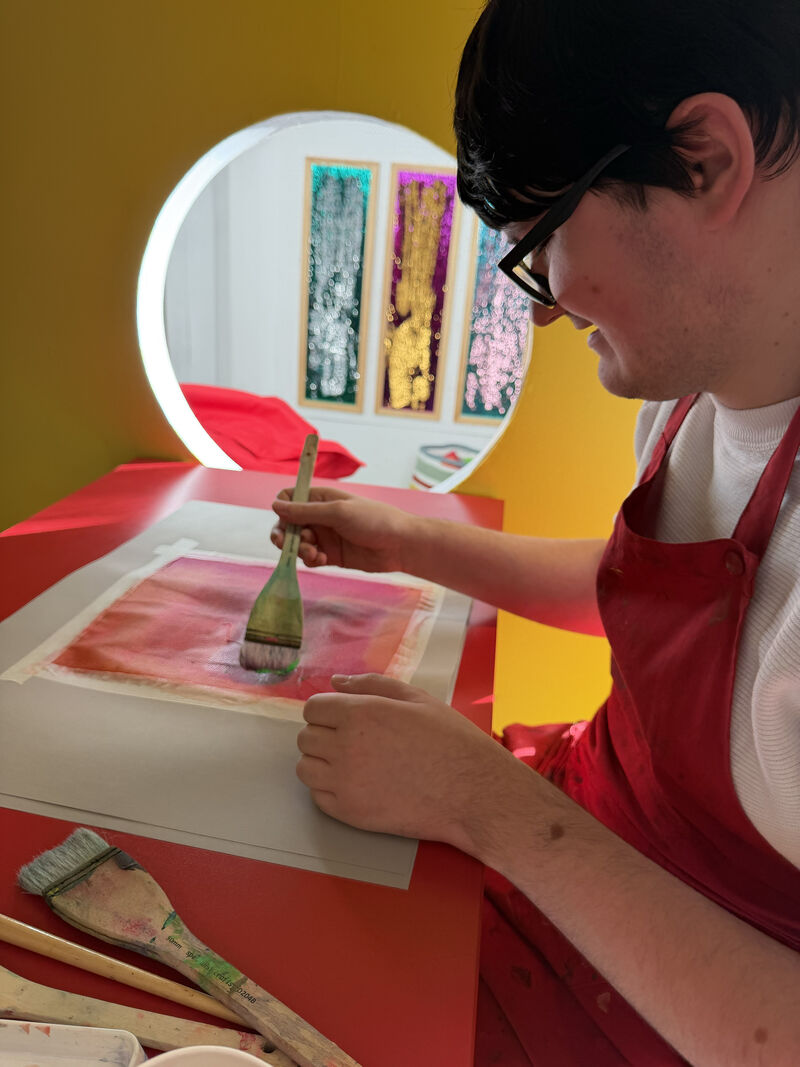 Person painting onto fabric