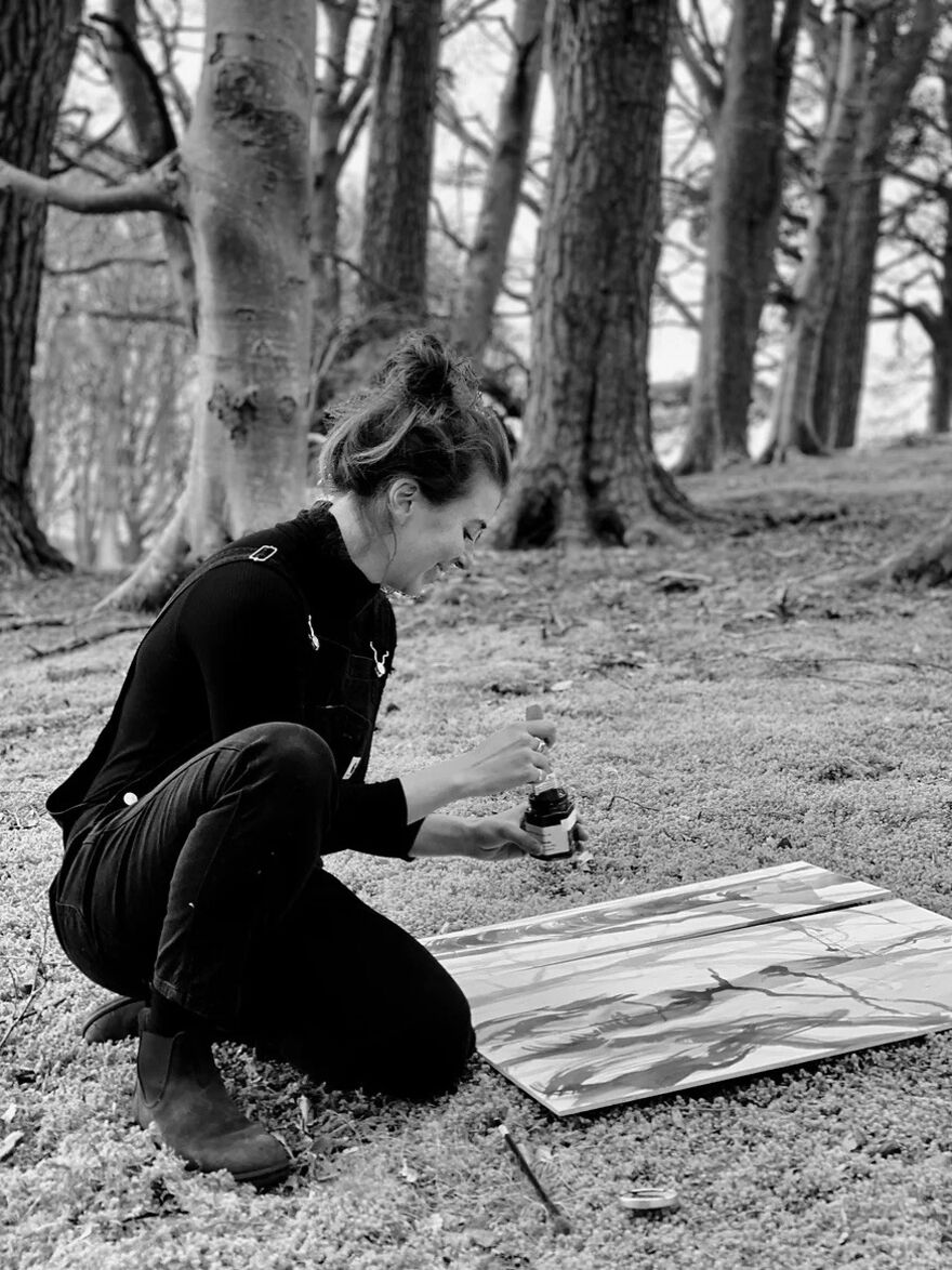 Black and white photo of Susannah Emily doing mokulito lithougrphy i the woods