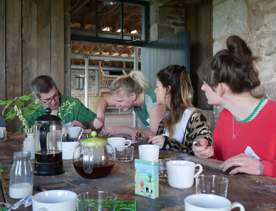 Louise Forbes showing a group of people how to carve a spoon