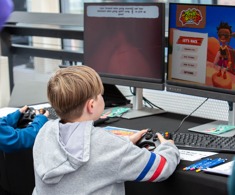 A young boy plays a game on a PC at Drop in and Play.