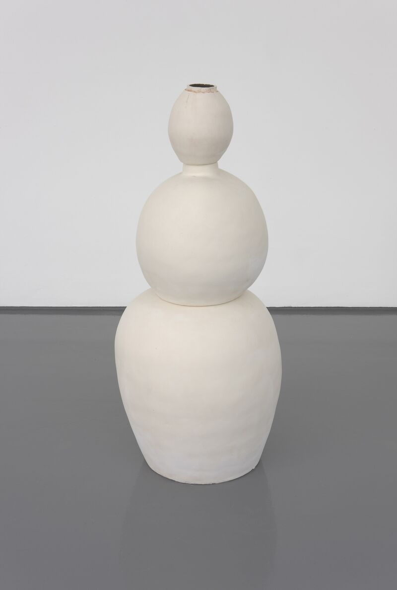 A sculpture from Nina Rhode's exhibition - a white vase, made up of 3 ovals in increasing size stacked on top of each other.