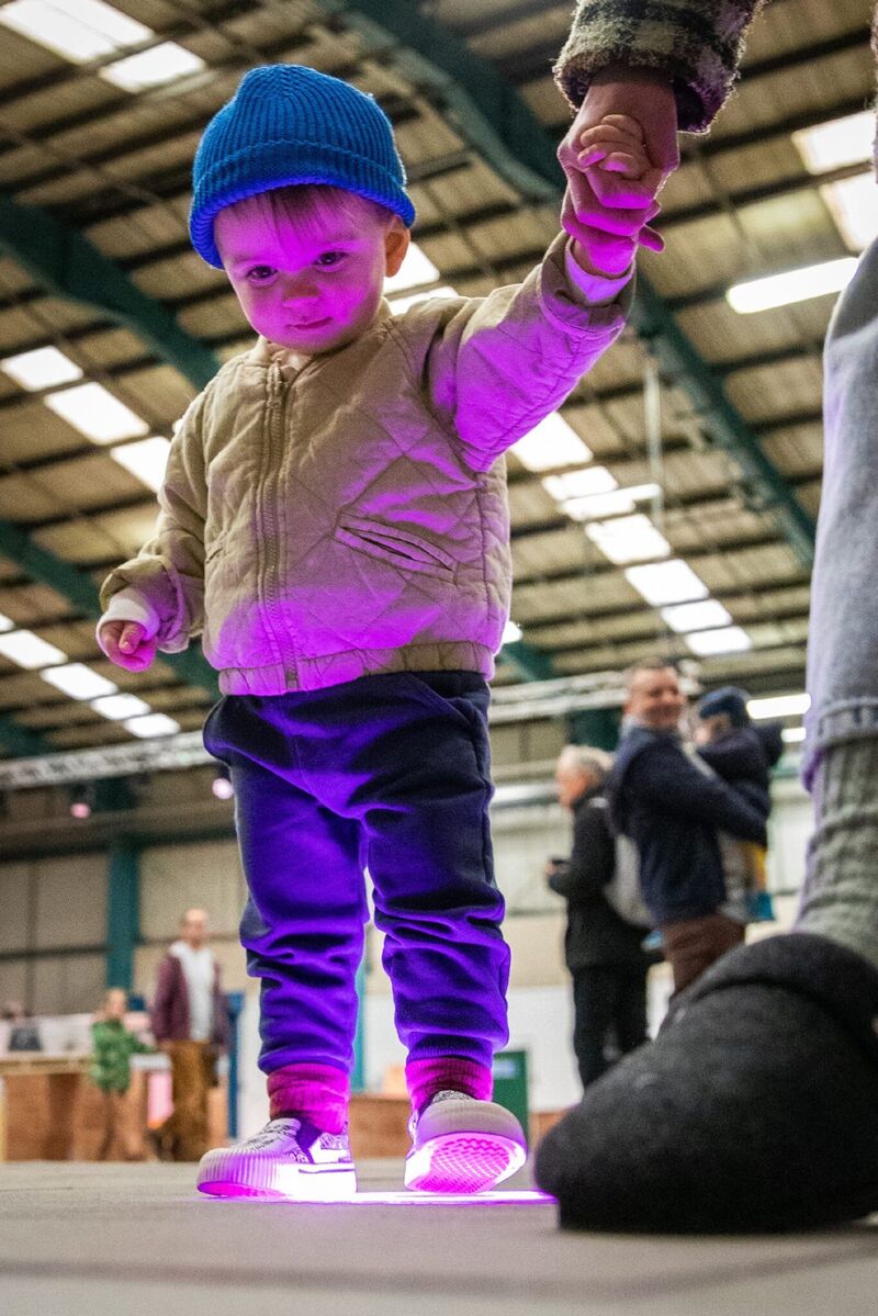 Child standing on a pink light