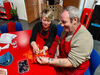 Artist showing a workshop participant how to do shibori fabric dying